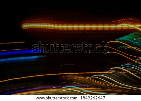 Light and stripes moving fast over dark background.