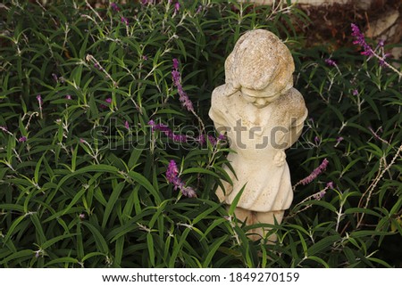 A garden statue of a child. Childhood concept photo. 