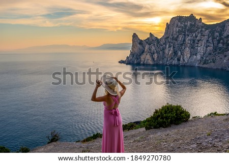 Girl by the sea in a picturesque bay
