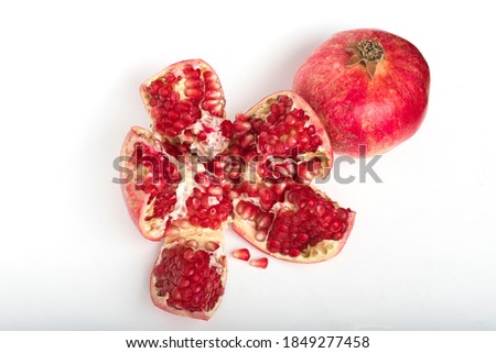 pomegranate with half of pomegranate isolated on a white background
