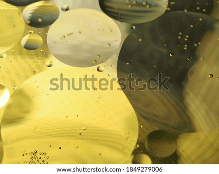 Abstract photography. Multi-colored circles on a multi-colored background. Red, yellow, pink, green, purple circles. Drops of oil on the water. Bokeh. The background