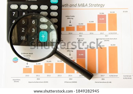  coins and pen in focus, calculator in the background. High quality photo