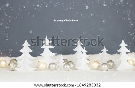 Christmas card. Merry Christmas. Paper fir trees with Christmas balls.