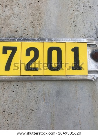 black 7201 numbers with yellow background
