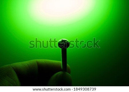 screw on a green background