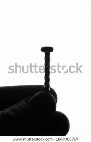 screw in hand on a white background