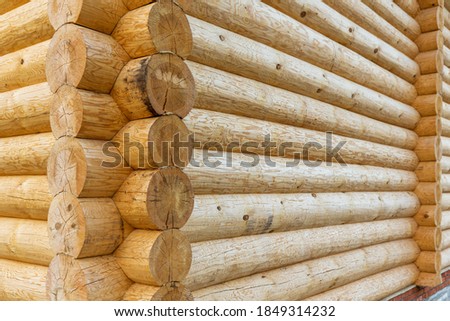corner of wooden house made of natural logs