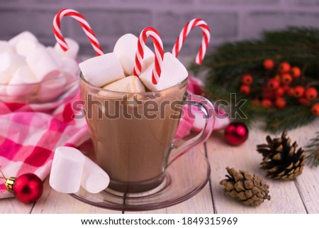 
Cup with Christmas cocoa with marshmallows on the background of Christmas decorations.