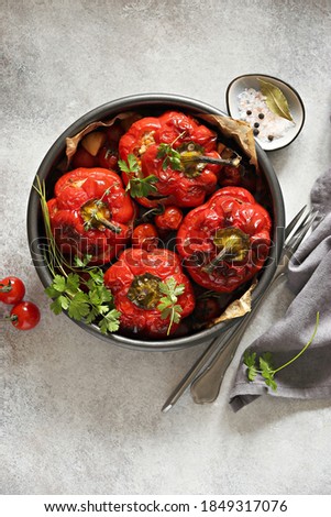 Oven backed red paprika stuffed with meat and vegetables. Overhead view, selective focus