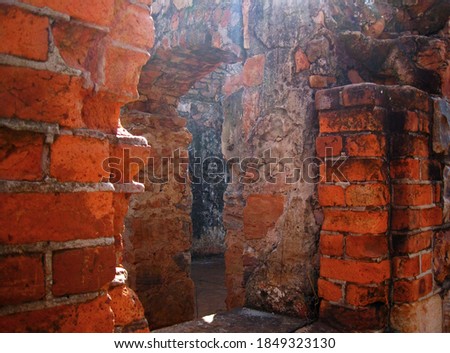 INNER STRUCTURE OF ROOMS IN AN OLD FORT CRUMBLING AND IN RUINS                               