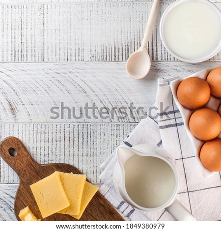 Flatlay a variety of dairy products, cheese, farm eggs. The concept of the farmer's market. Copy space.