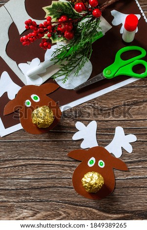Funny Gift with candy Christmas deer. Handmade. Children's creativity project, crafts, crafts for kids.