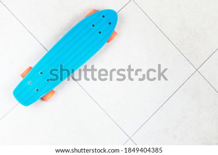 Skateboard cruiser style blue yellow and orange view from above