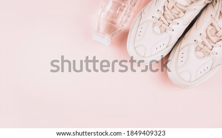 Healthy lifestyle. Sports equipment on a pink background. Sports concept. The apartment was lying. Top view with copy space. Banner.