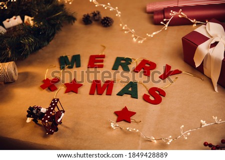 Colorful Merry Christmas Text on Craft paper background. Merry Christmas Greeting.