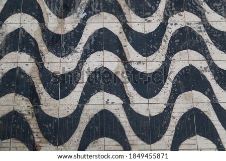 A closeup shot of the patterned textured wall with tiles