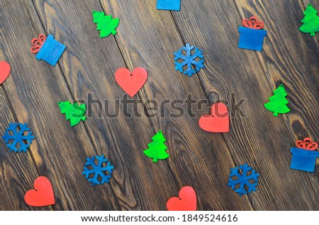 wooden christmas pattern decor heart-shaped toys, gift, christmas tree and snowflake on wooden background top view