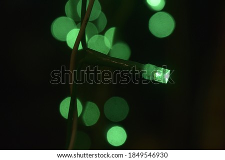 green single blurry light with black background and green lights
