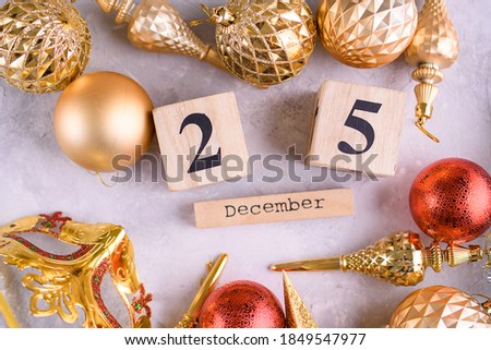 New Year's content, Christmas tree gold toys, a small Christmas tree, lights, wood eco cubes with the figure on December 25. Merry Christmas and New Year