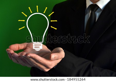 Businessman showing a virtual bulb symbol and idea concept