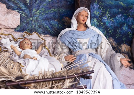 Nativity scene - beautiful statues of the Virgin Mary and baby Jesus in a manger. Christmas holiday