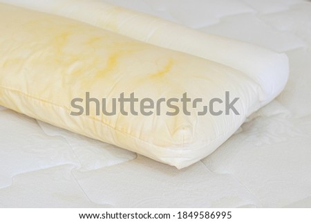 Pillow with yellow saliva stains
