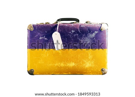 Old suitcase with the flag of Ukraine. Isolated on a white background