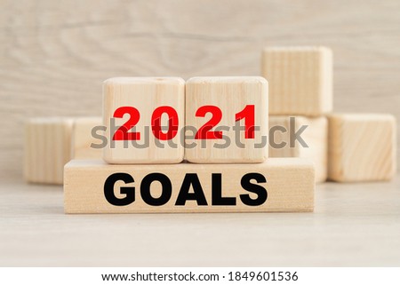 the word 2021 GOALS is written on a wooden cubes structure. Cube on a bright background. Can be used for business, marketing, financial concept. Selective focus.