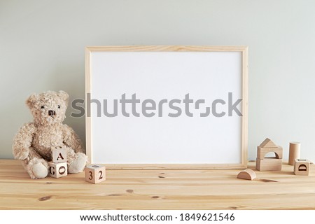 Nursery frame mockup, empty wooden horizontal frame for baby room or kids room wall art, print, photo.     Royalty-Free Stock Photo #1849621546