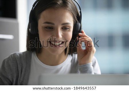 We are always glad to help you! Friendly capable young female in headphone set employee worker of hotline call center client support service talking to microphone assisting answering customer question Royalty-Free Stock Photo #1849643557