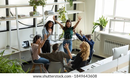 Good job! Happy laughing excited diverse coworkers teammates friends having fun meeting at break time in office area receiving reward for successful work, celebrating victory, achievement, good news Royalty-Free Stock Photo #1849643608