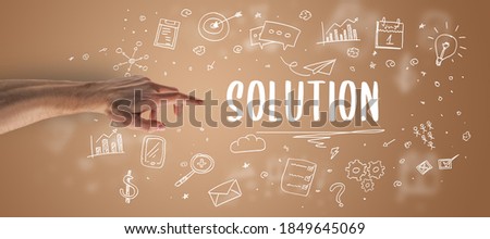 Close-Up of cropped hand pointing at SOLUTION inscription, modern business solution concept