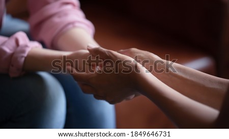 Professional assistance. Close up of biracial female psychologist therapist hands holding palms of millennial woman or teenage girl patient client talking consulting helping accept difficult situation Royalty-Free Stock Photo #1849646731