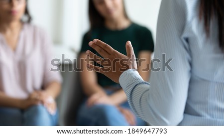 Speaker talking. Close up of unknown young woman business leader trainer lecturer coach speaking on briefing seminar training conference meeting with audience of colleagues partners investors students Royalty-Free Stock Photo #1849647793