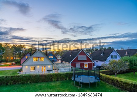 View of traditional Scandinavian timber houses in autumn season at sunset Royalty-Free Stock Photo #1849663474
