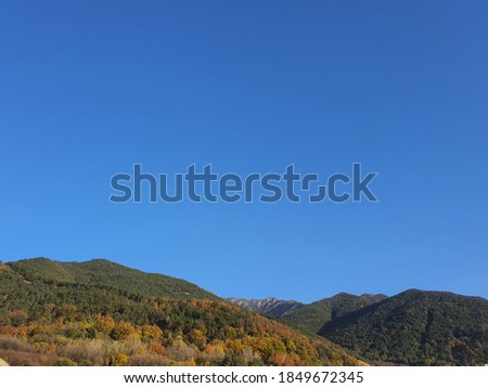 a cloudless clear sky and mountains