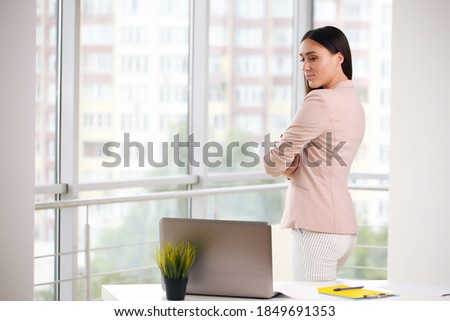 Beautiful business woman on the background of the modern office