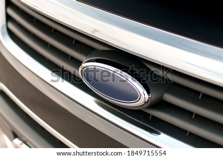 Black SUV with large chrome grille. Logo.