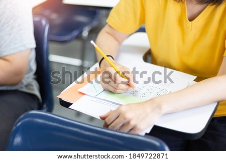 high school,university student study.hands holding pencil writing paper answer sheet.sitting lecture chair taking final exam attending in examination classroom.concept scholarship for education abroad Royalty-Free Stock Photo #1849722871