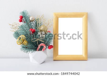 Christmas Golden Frame poster mock up template with New Year bouquet. Red, gold and white decorations.