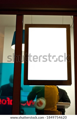 Banner for advertising in a shop window. Sign Board behind the glass. Copy space and space for text. Mockup for design. Blank template for advertising.