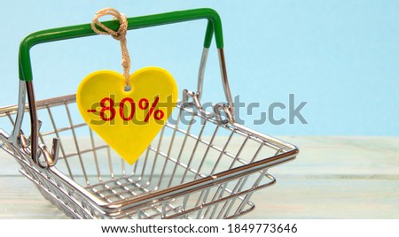 Shopping basket and heart with letters -80 percent. Sale and discount concept.