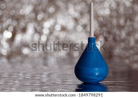 Plastic medical douche bag on a shiny background close-up Royalty-Free Stock Photo #1849798291