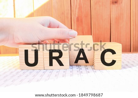 word URAC on wooden blocks, white background, business concept. business and Finance