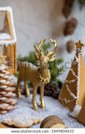 Christmas golden deer Rudolf at festive decoration. Concept of holiday card for Christmas and New Year