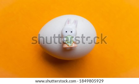 Easter Bunny Egg On Yellow Color Background Stock Photo