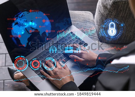 Businesswoman typing on computer in office. Financial and research icon hologram. Double exposure.