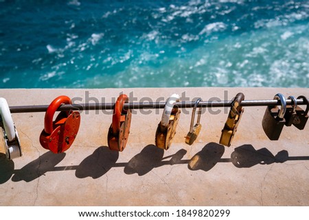 Closed wedding locks - a tradition, many padlocks in the traditional beautiful place of the wedding ceremony in the mountains. Colorful padlocks against the backdrop of the sea and mountains.


