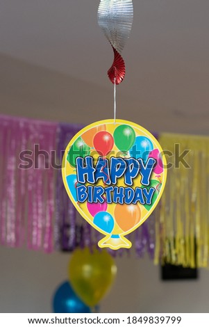 happy birthday sign hanging from the ceiling