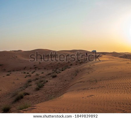 Picture of a boy and SUV in the desert. Outdoors